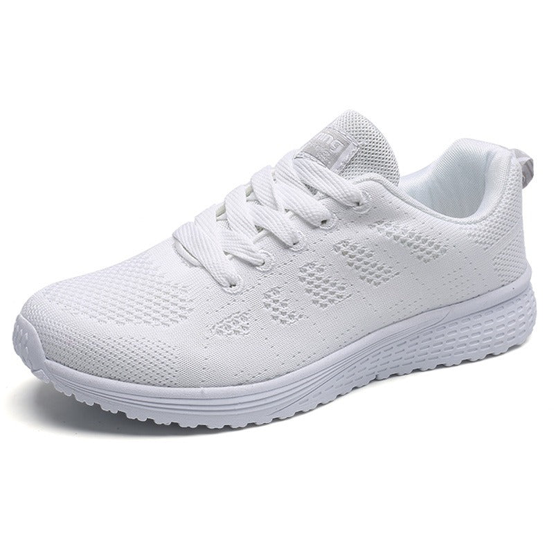 White breathable mesh lace-up flat sneakers for women, perfect for comfort and style in any casual outfit.
