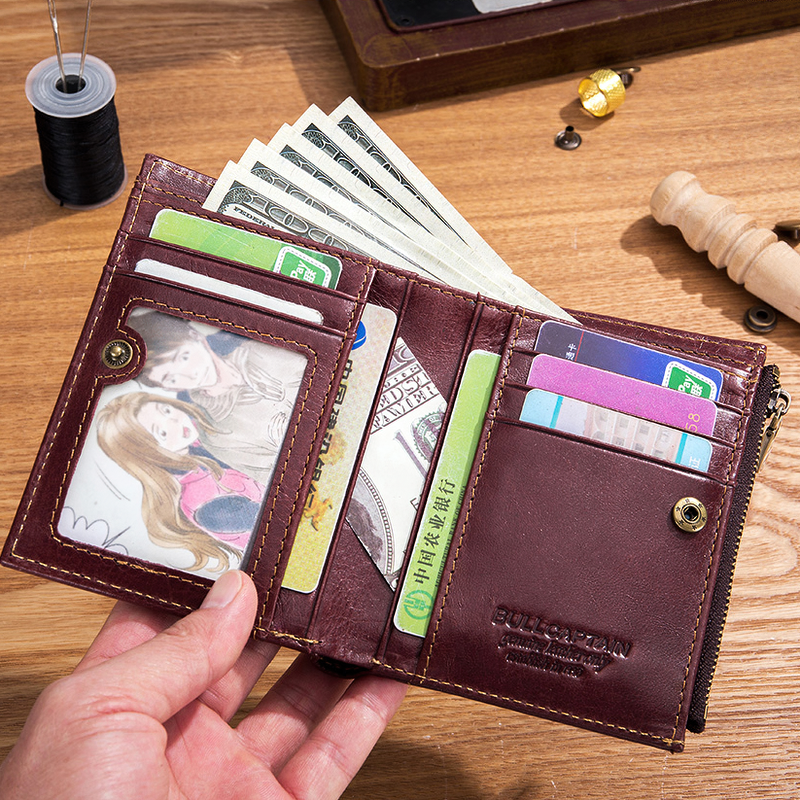 Brown genuine leather tri-fold wallet showcasing cash and cards, perfect for alternative fashion and practical use.