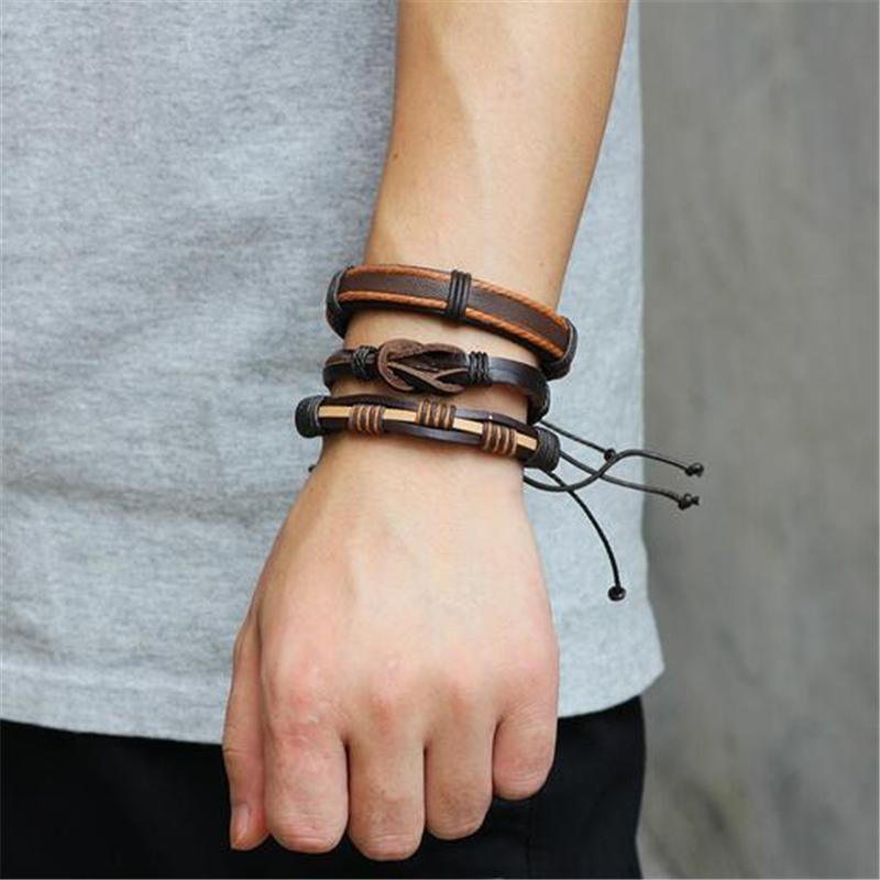 Brown leather bracelet and braided rope wristband set on a man's wrist, showcasing rock style charm elements.