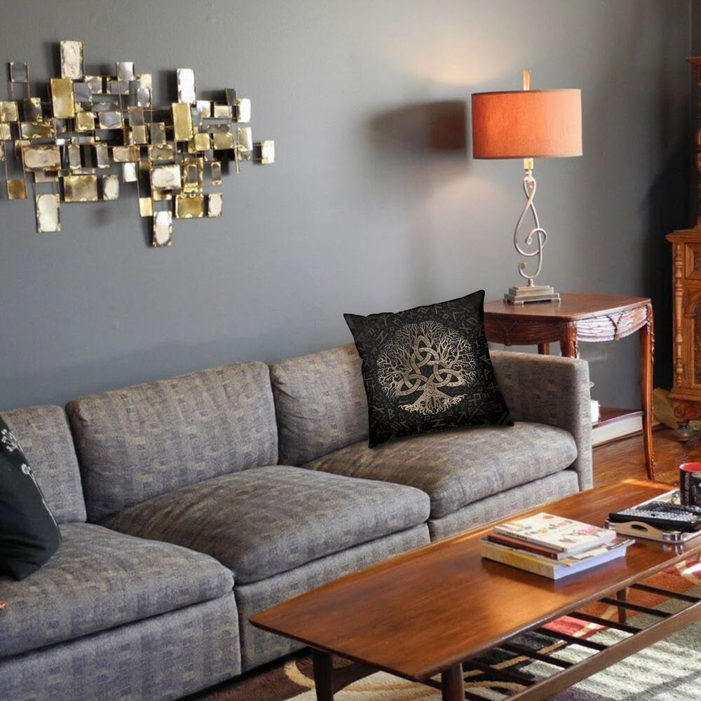 Decorative brown pillowcase with Triquetra design on a stylish living room sofa.