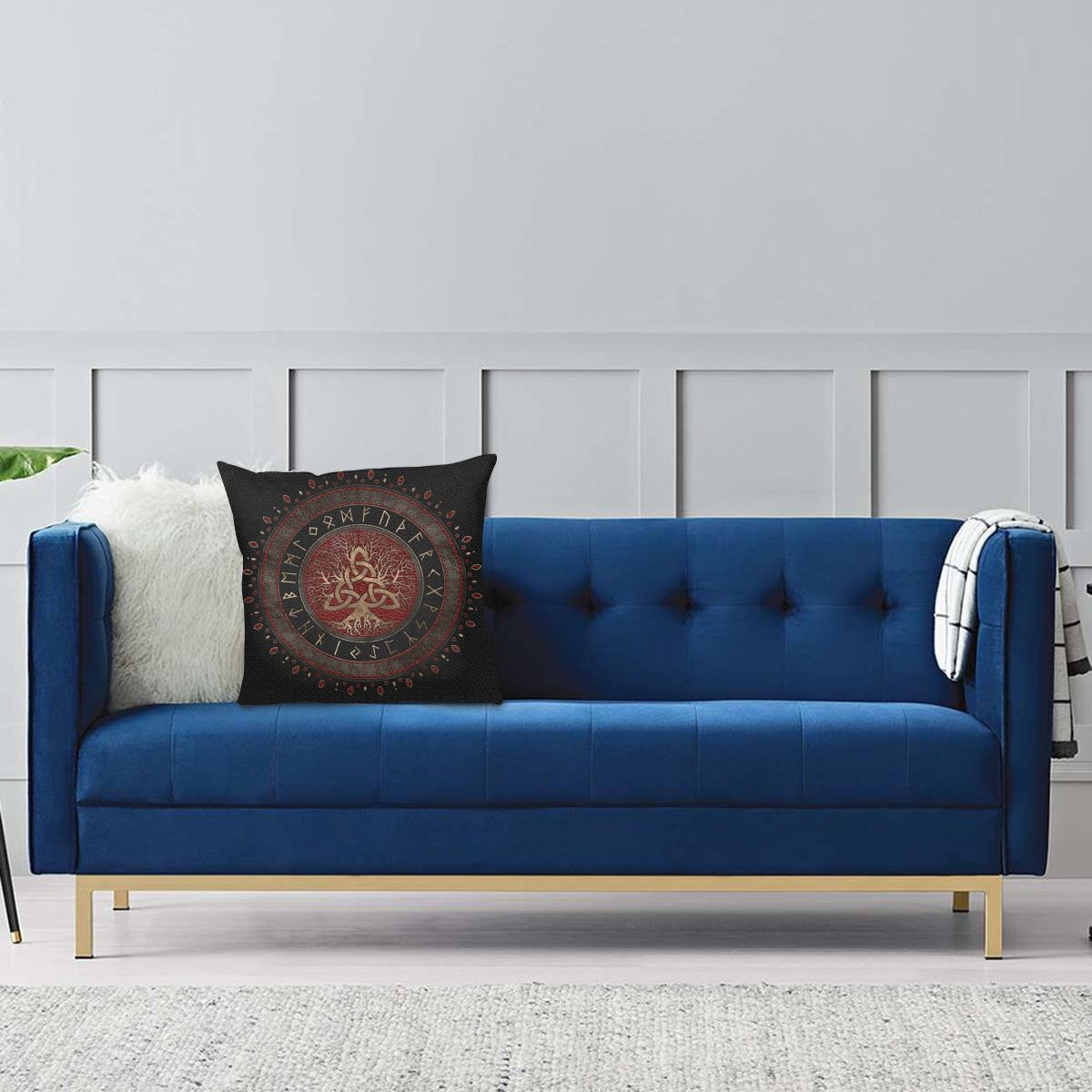 Vintage brown pillow case with Tree of Life and Triquetra design on a stylish blue couch.