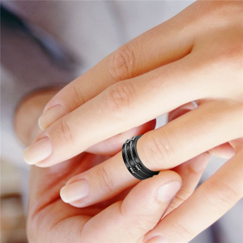 Brushed 316L stainless steel unisex ring with cable wire design on a hand, showcasing alternative jewelry style.