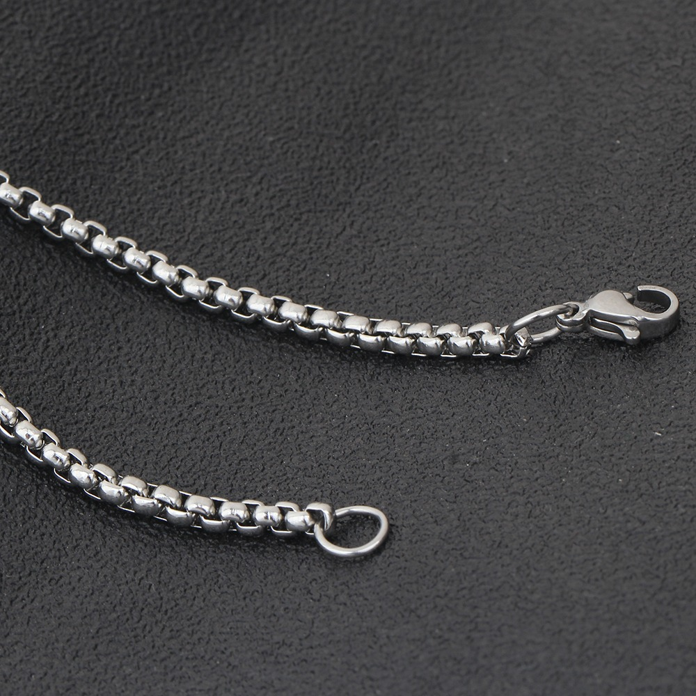 Close-up of a stainless steel chain necklace featuring a secure clasp for alternative fashion jewelry.