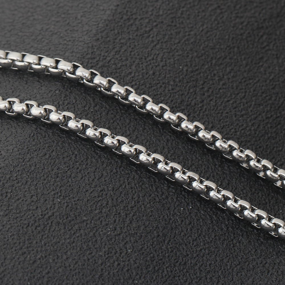 Close-up of shiny stainless steel chain links for jewelry, perfect for enhancing alternative fashion styles.