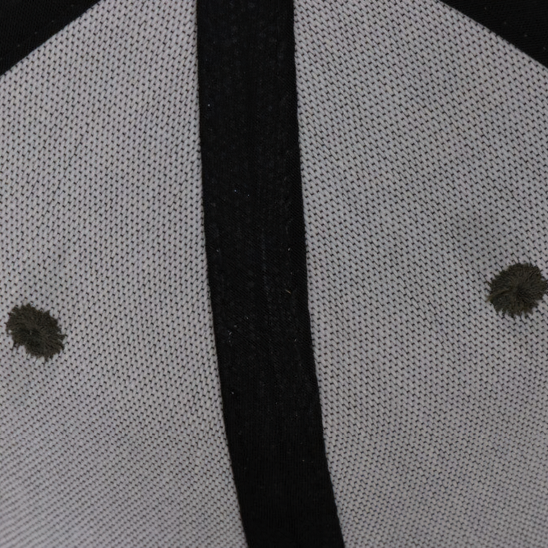 Inside view of a camouflage snapback cap showing quality stitching and breathable polyester fabric.
