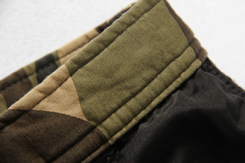 Close-up of camouflage tactical pants waistband showcasing quality stitching and cotton fabric.