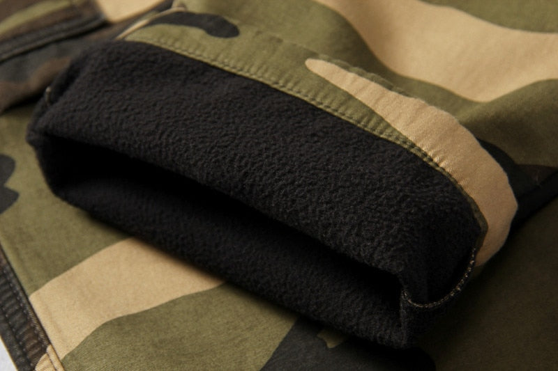 Close-up of camouflage tactical pants cuff showing soft fleece lining for comfort and warmth.