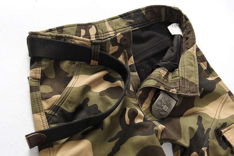 Close-up of camouflage tactical pants featuring a sturdy belt and pocket details, ideal for outdoor activities and military wear.