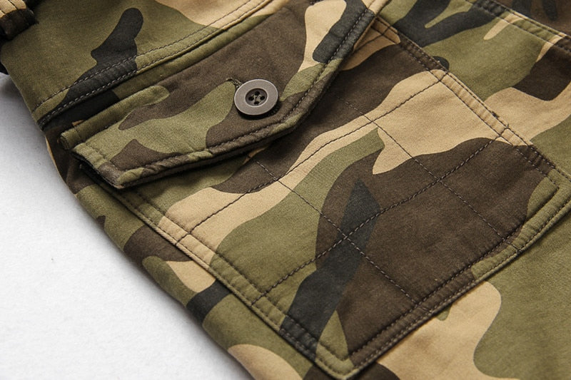 Close-up of camouflage tactical pants showing pocket and fabric details in army green shades.