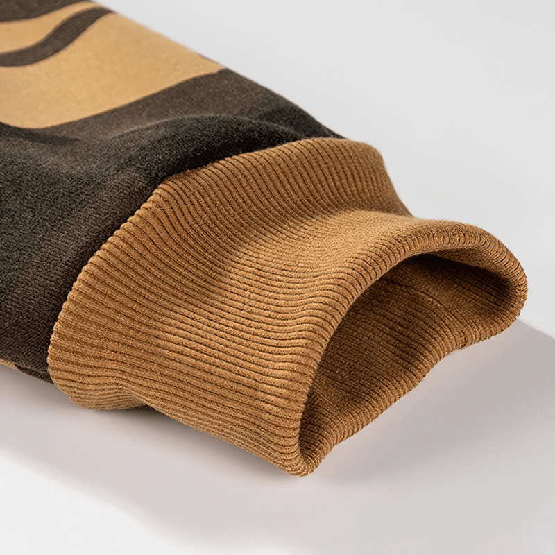 Close-up of a warm men's camouflage hoodie sleeve with ribbed cuffs, showcasing alternative fashion style.