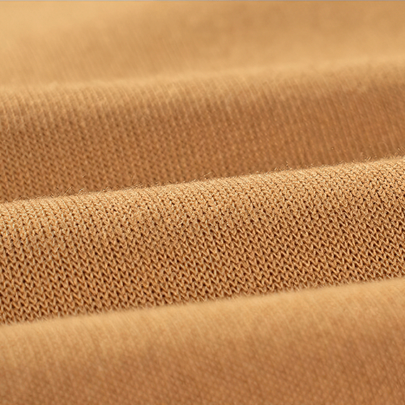 Close-up of soft beige fabric texture, showcasing the quality of men's fleece hoodies.