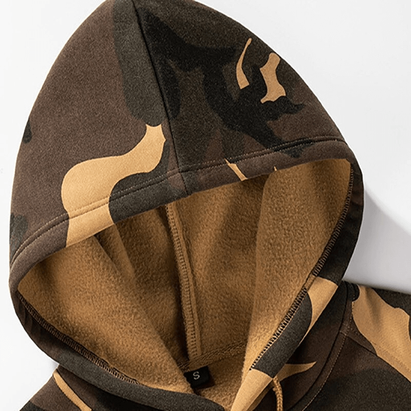 Close-up of a camouflage men's hoodie with soft fleece lining, perfect for alternative fashion and warmth.