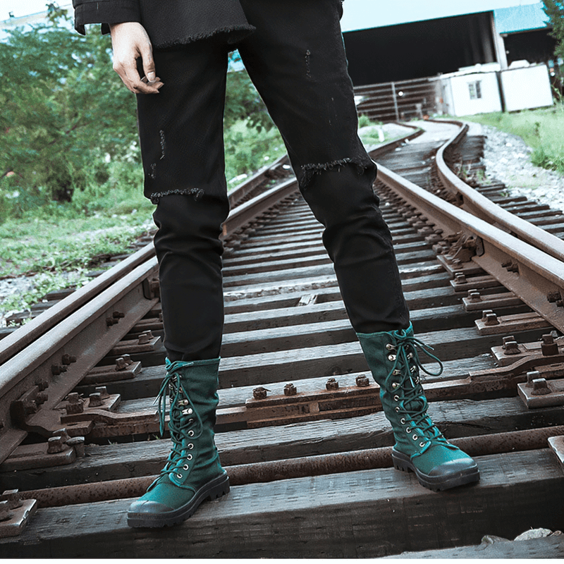 Men's canvas lace-up mid-calf tactical boots in green on railway tracks, showcasing a stylish casual look.