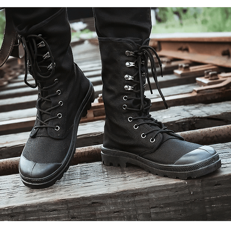 Men's canvas lace-up boots showing stylish mid-calf design, perfect for casual wear and tactical purposes.