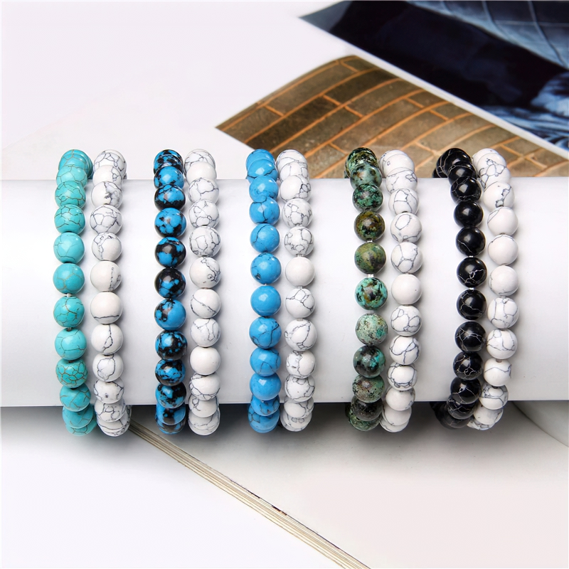 Colorful unisex natural bead bracelets displayed in a row on a magazine, showcasing trendy casual fashion accessories.