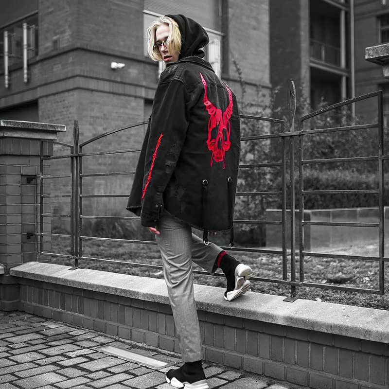 Men's gothic black denim jacket with oversized cut and striking red skull print on back, stylish alternative fashion.