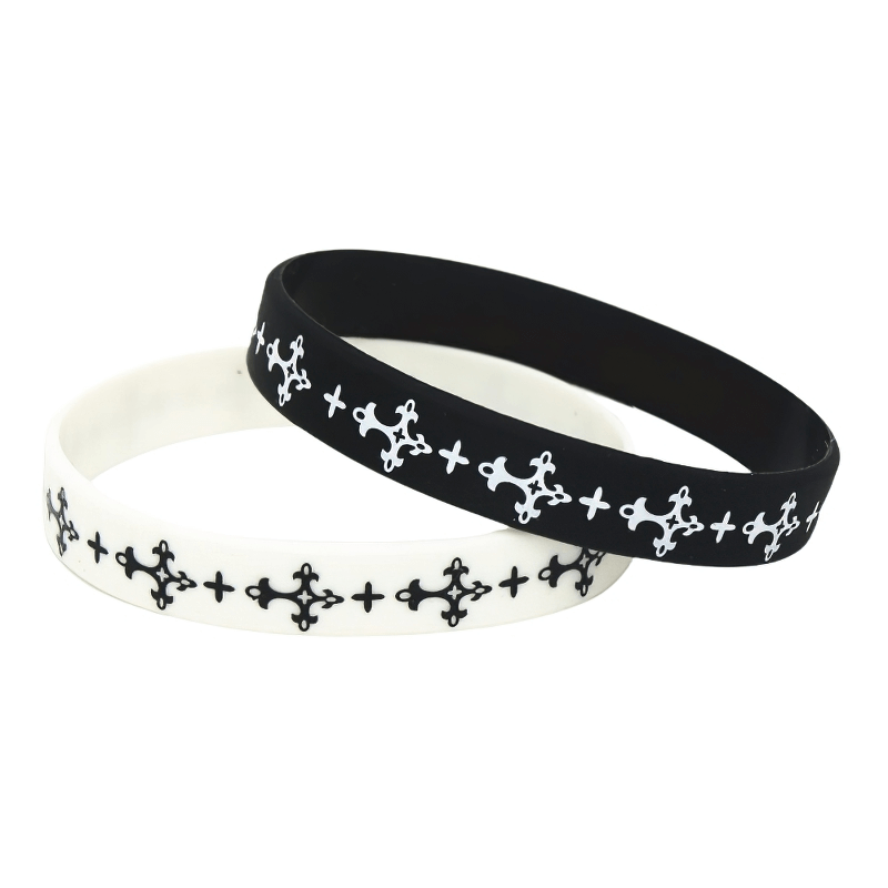 Black and white silicone wristbands with stylish patterns, perfect sports fashion accessory for any outfit.