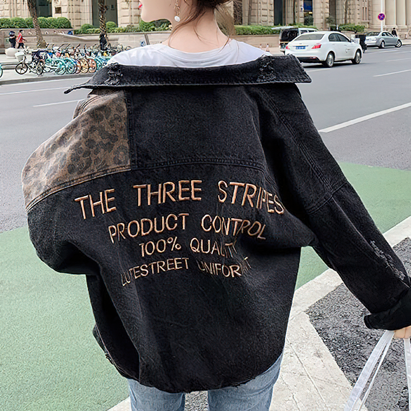Stylish causal black denim jacket with leopard embroidery and unique lettering, perfect for everyday wear.