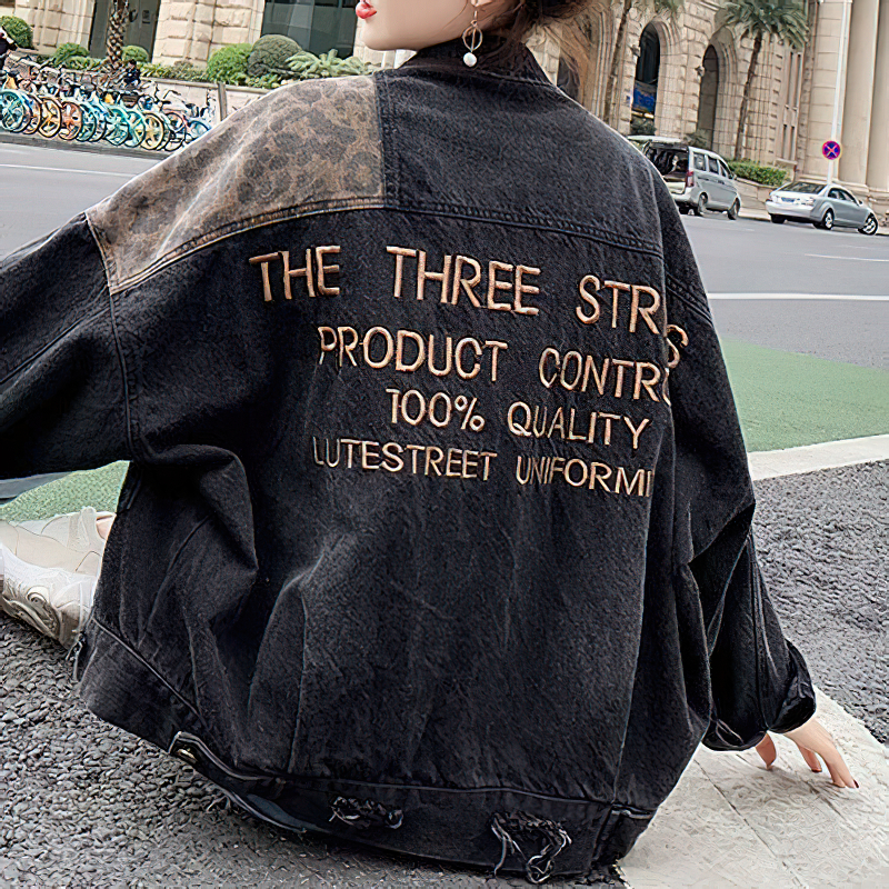 Casual black denim jacket with leopard embroidery, showcasing stylish text design for modern women.