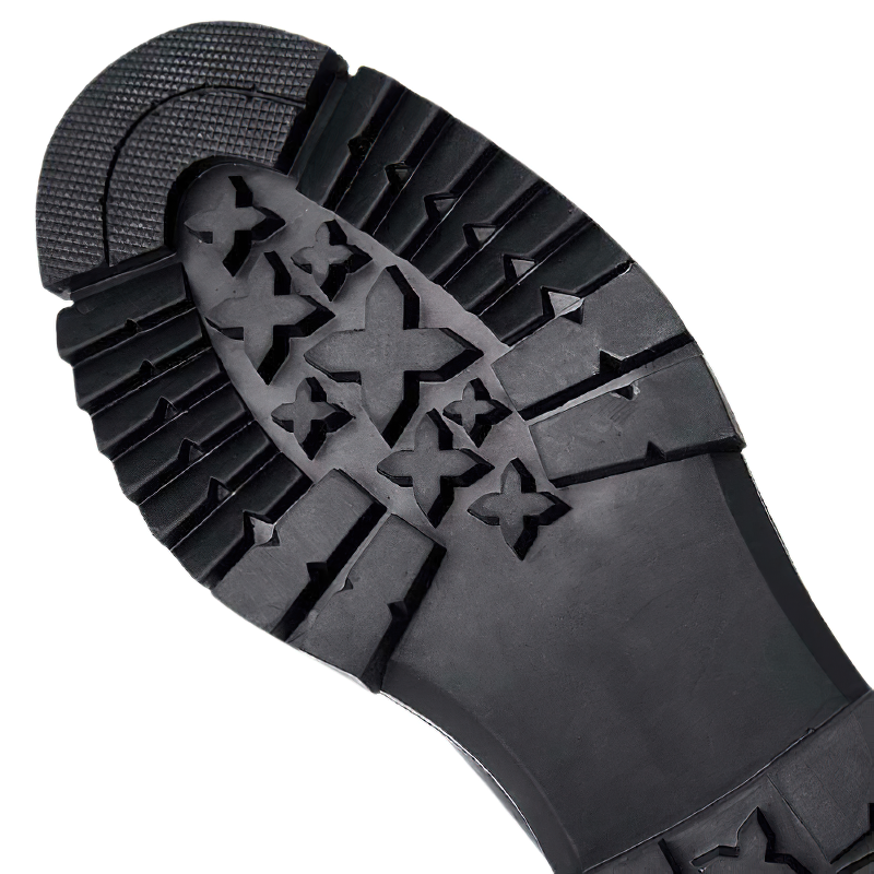 Close-up of the rugged outsole of men's leather high boots, showcasing thick traction pattern for superior grip.