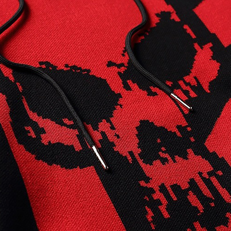 Close-up of a casual knitting hoody featuring a bold skull print in red and black, highlighting its trendy oversized style.