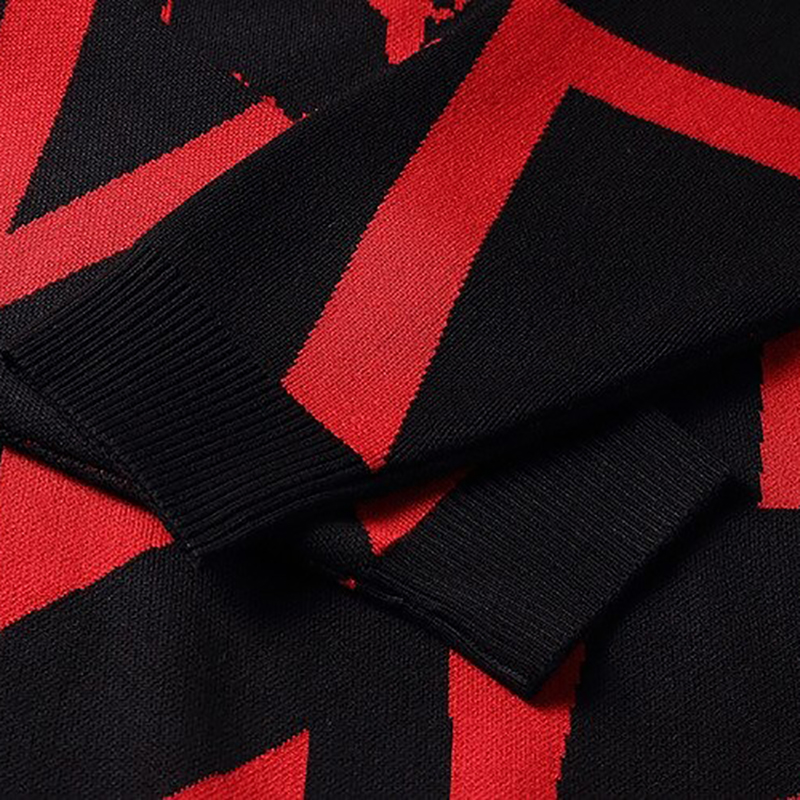 Close-up of a casual hoodie featuring a bold red and black skull print design.