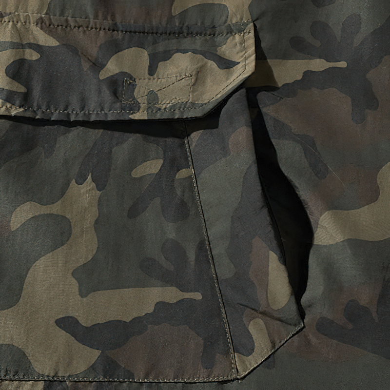 Close-up of camouflage fabric featuring pockets, perfect for stylish men's hoodies and casual wear.