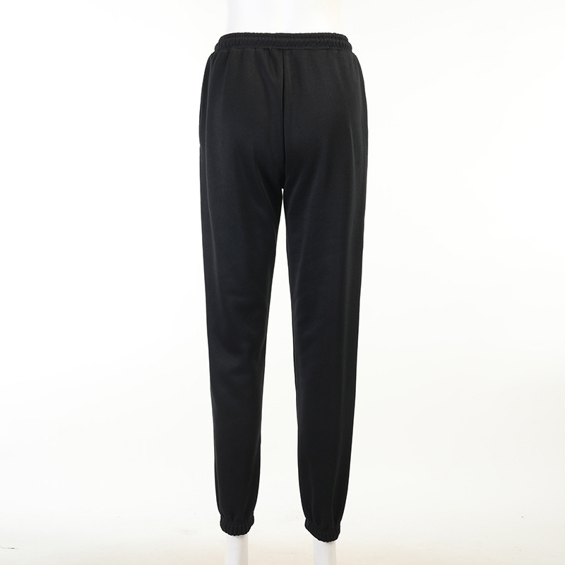 Back view of casual loose black pants for women with elastic waistband and stylish cut.