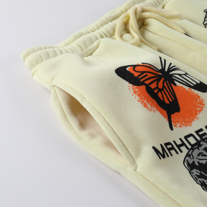 Close-up of yellow casual loose pants with butterfly print and adjustable waistband, perfect for relaxed outfits.