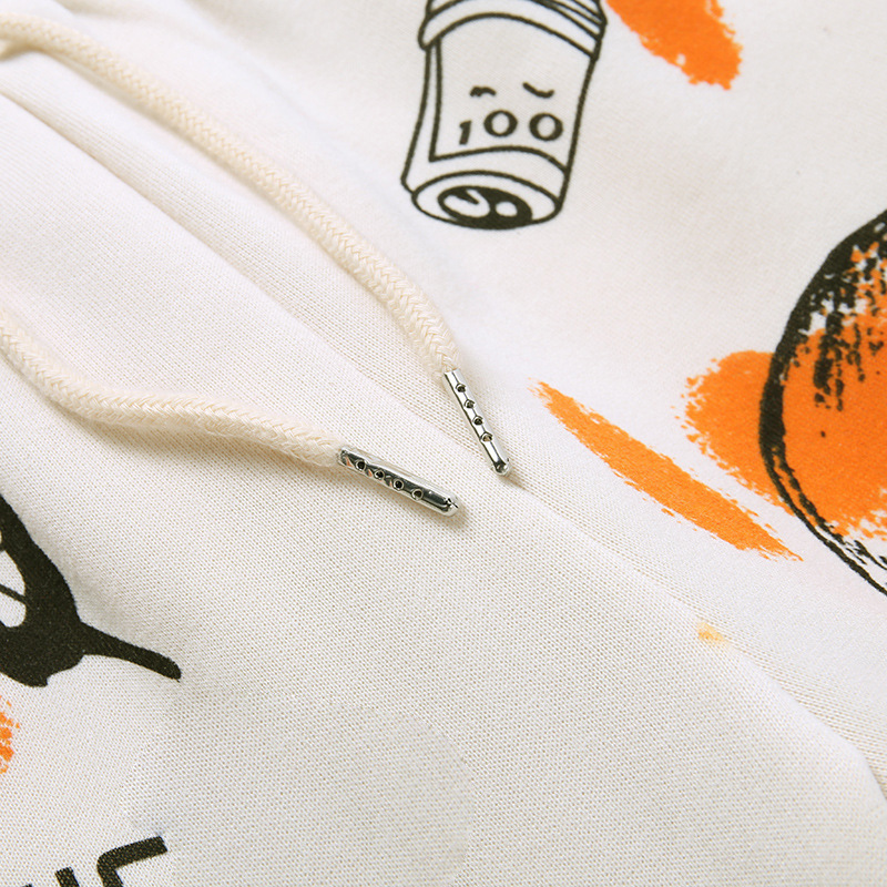 Close-up of casual women's pants featuring cool graffiti designs and stylish drawstrings.