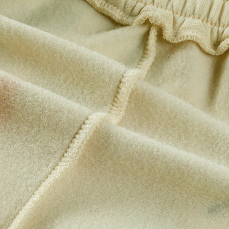 Close-up of soft fleece fabric showcasing the elastic waistband of casual loose pants for women.