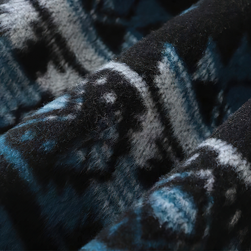 Close-up of soft fabric with geometric patterns in blue and black tones, perfect for a stylish casual shirt.