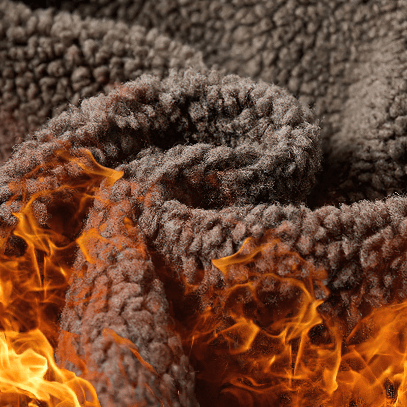 Close-up of soft brown fabric with simulated flames for a cozy, warm look.