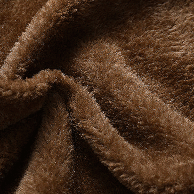 Close-up view of soft brown fleece fabric, highlighting its warmth and texture ideal for motorcycle jackets.