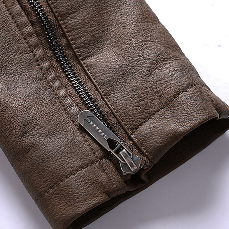 Close-up of the zipper on a brown faux leather motorcycle jacket for men, showcasing quality craftsmanship.