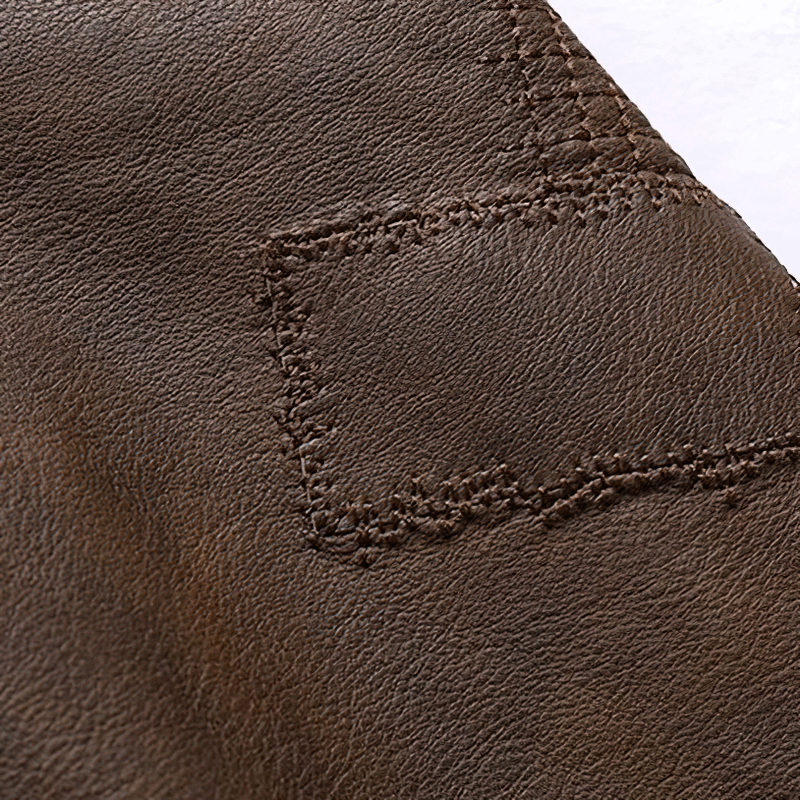 Close-up of high-quality brown faux leather with stitching detail, ideal for a men's motorcycle hooded jacket.
