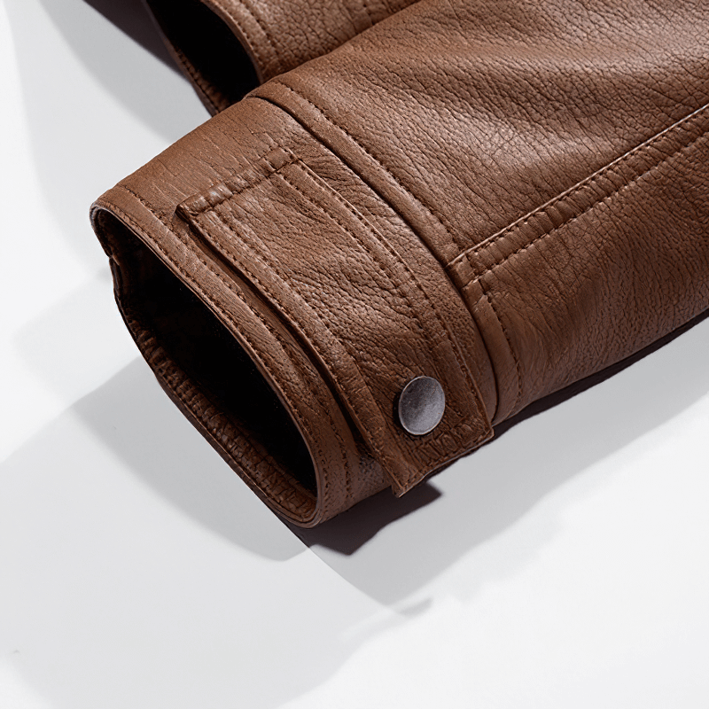 Close-up of the sleeve of a brown PU leather motorcycle jacket for men, highlighting the detailed stitching and snap button.