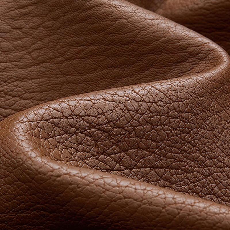 Close-up of rich brown PU leather texture, perfect for stylish motorcycle jackets and warm winter wear.
