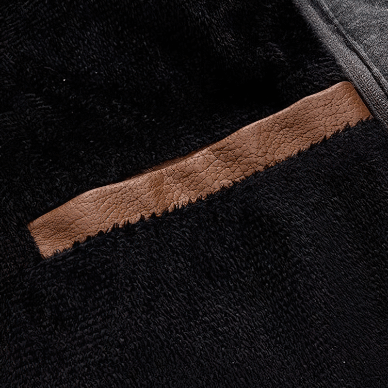 Close-up of the cozy fleece lining of a casual motorcycle PU jacket with a contrasting leather pocket insert.