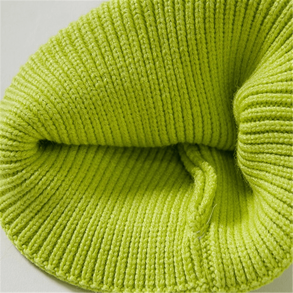Close-up view of the interior of a vibrant green knitted hat, showcasing soft, ribbed texture.