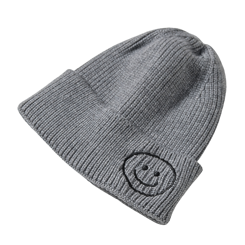 Casual grey knitted hat with smiley face print, unisex design for warmth and style. Perfect accessory for everyone!