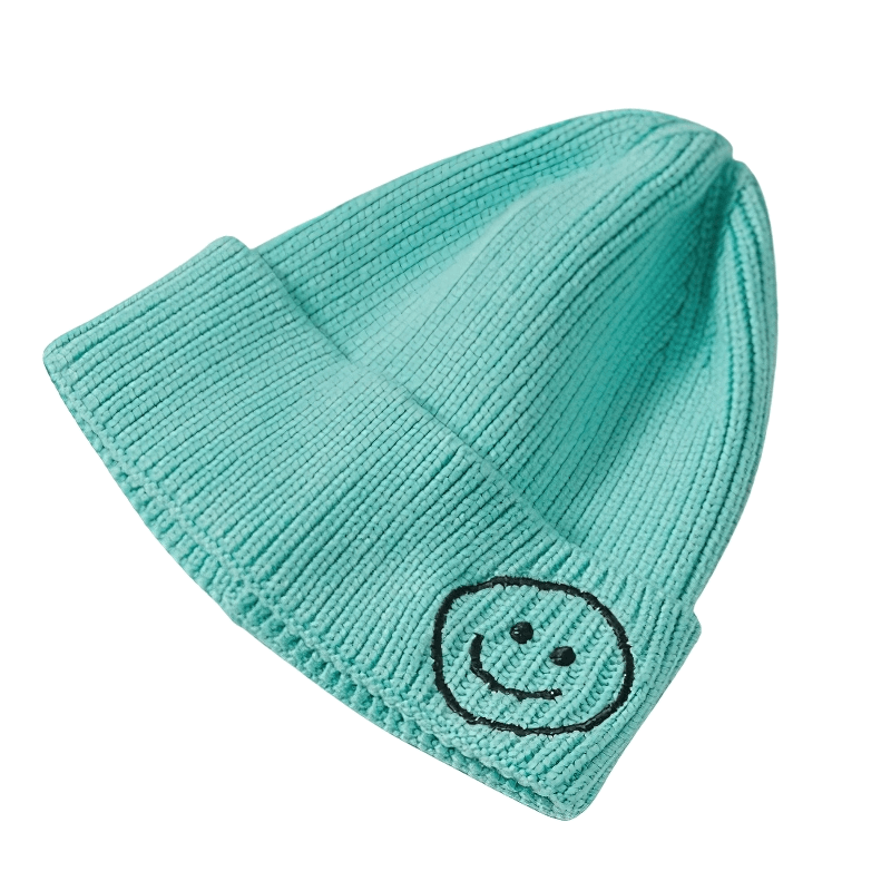 Casual smiley face knitted hat in teal, unisex warm accessory for men and women, perfect for a cheerful outfit.