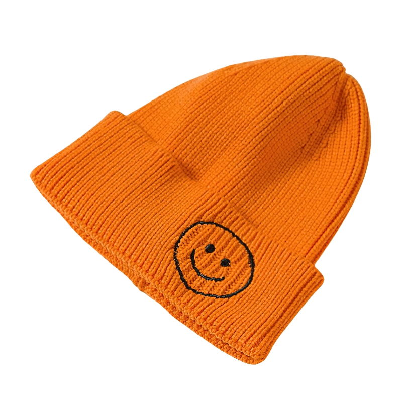 Casual orange knitted hat with smiley face print, perfect unisex accessory for warmth and style.