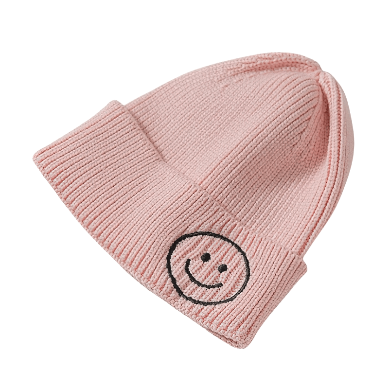Casual pink knitted hat with smiley face print for men and women, perfect for cozy and stylish winter looks.