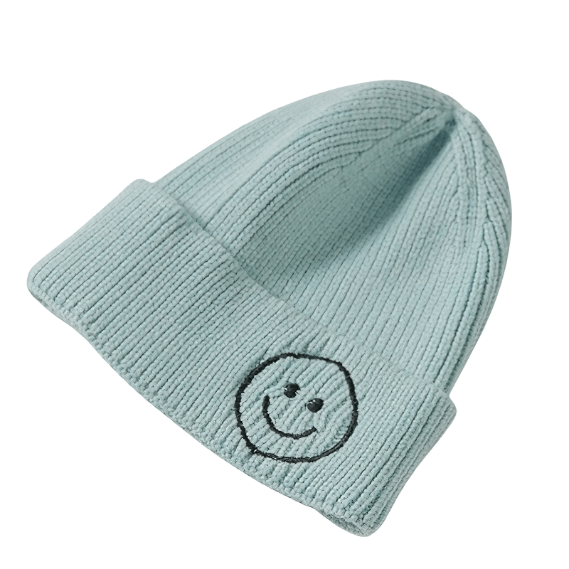 Casual unisex knitted hat in light blue with smiley face print, perfect for warm and cozy moments.