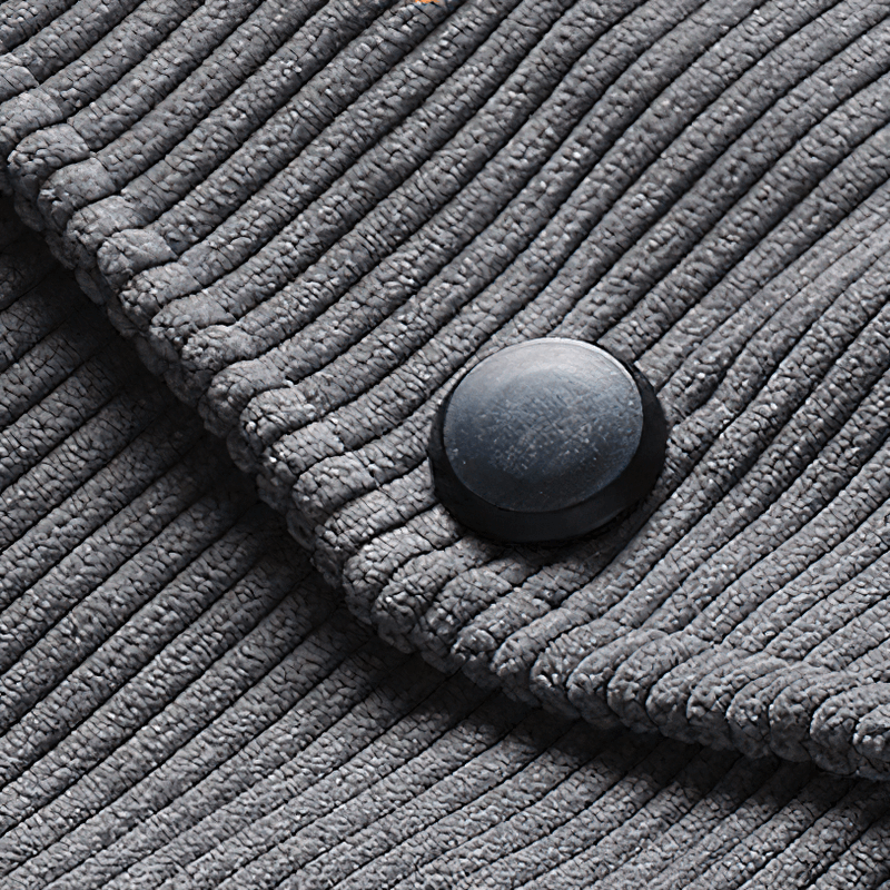Close-up of gray corduroy fabric with ribbed texture and button detail for men's jacket.