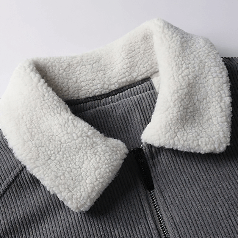 Close-up of a men's gray corduroy jacket featuring a soft white fur collar, perfect for casual style and warmth.