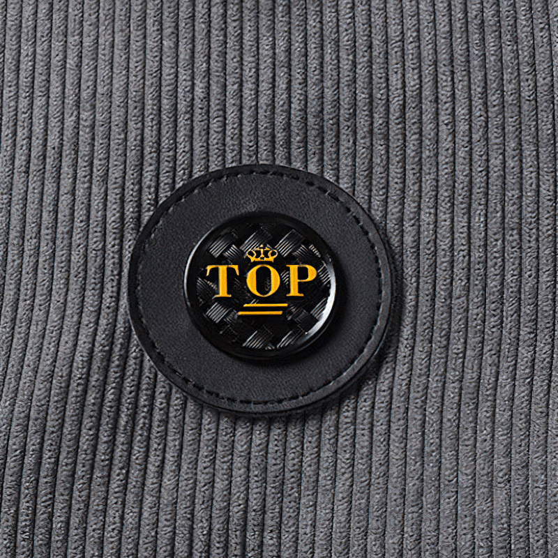 Close-up of a gray corduroy jacket featuring a stylish 'TOP' logo badge on the fabric.