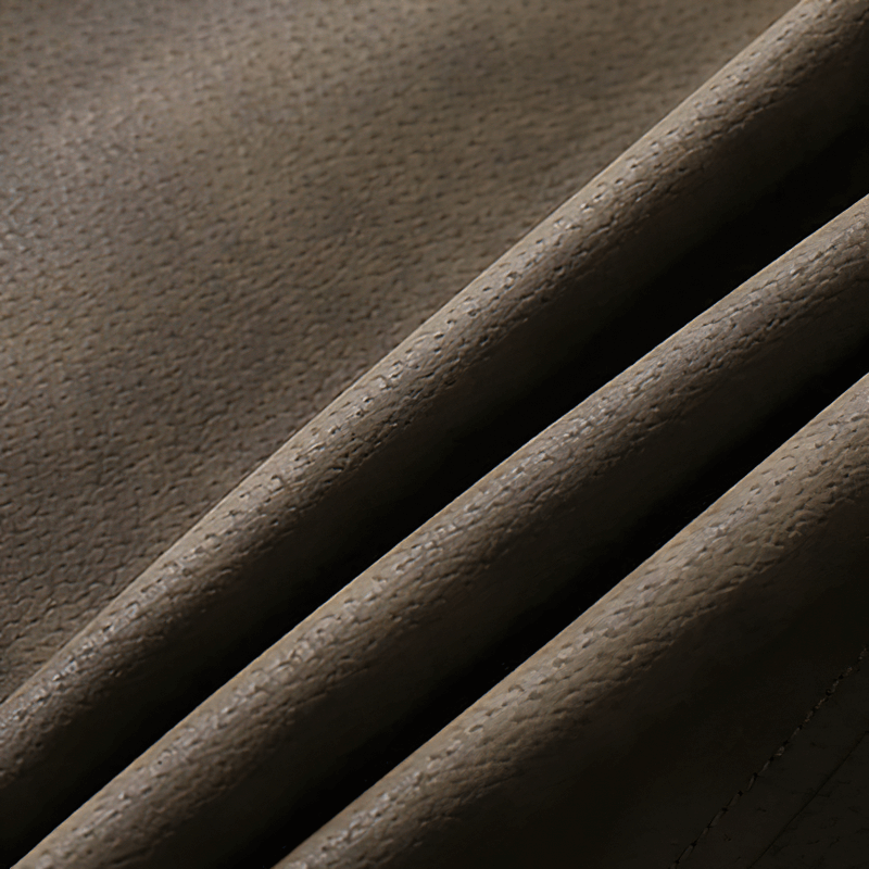 Close-up of soft faux leather fabric showcasing texture and quality for men's casual jackets.