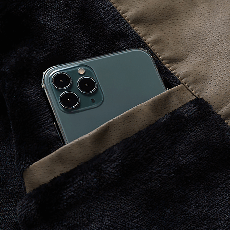 Smartphone nestled in the pocket of a soft fleece jacket, perfect for stylish convenience.